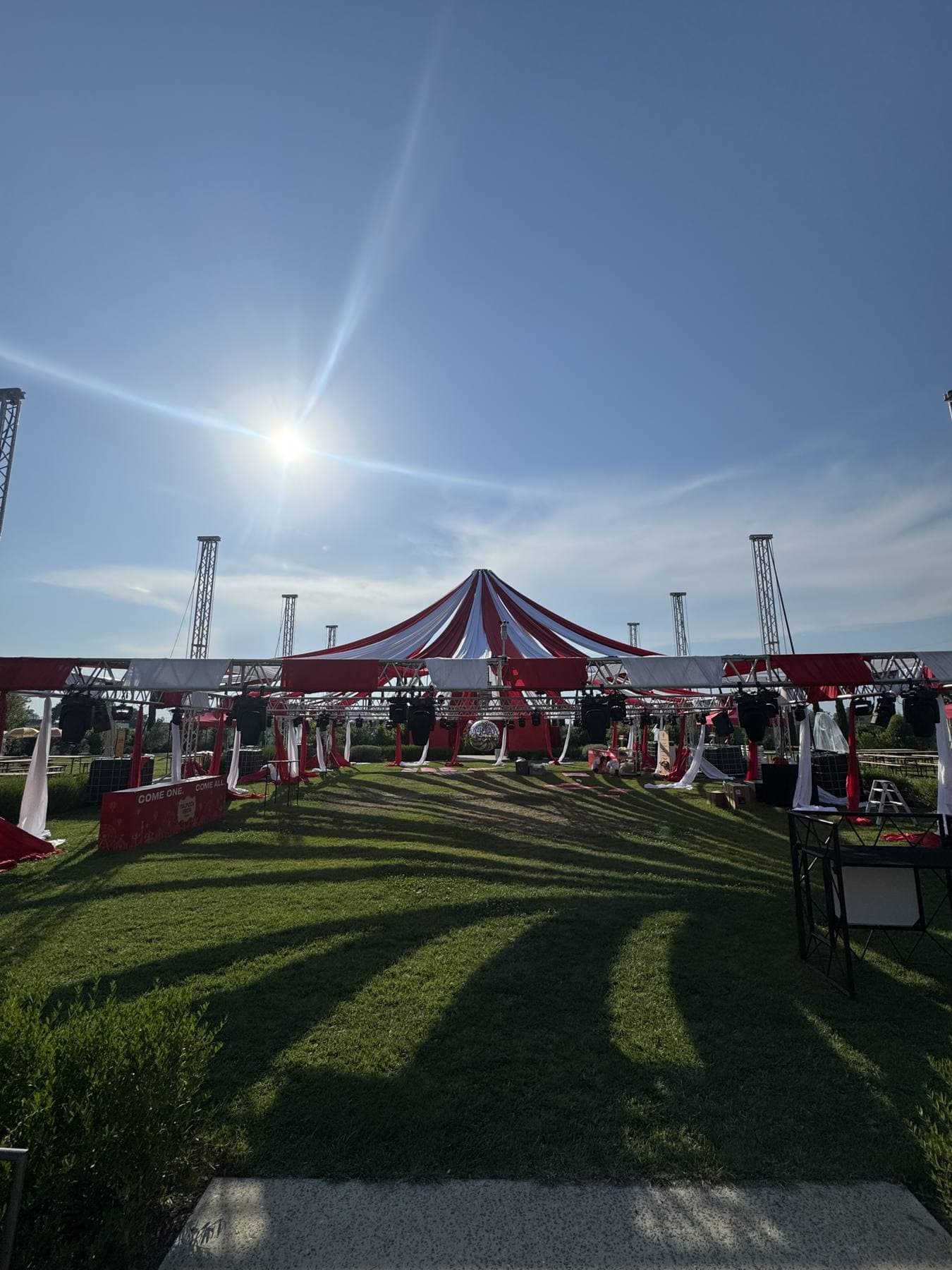 Allestimento con tendone rosso e bianco in un giardino per un evento